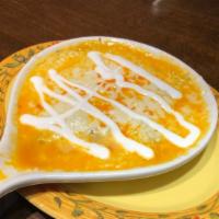 Queso Fundido · Vegetarian. Warm melted-cheese over pico de gallo, sour cream, and flour tortillas.