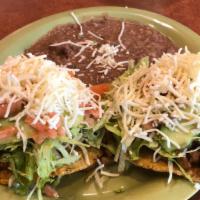 2 Tostadas Dinner · 2 tostadas with choice filling topped with lettuce, tomato, beans, cheese, sour cream.