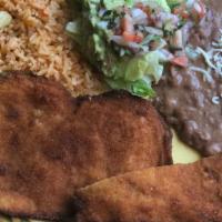 Milanesa De Pollo (Breaded Chicken) · Thinly sliced breaded chicken breast served with rice, beans, salad, and tortillas.