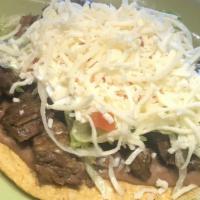 Tostada · Open face hard shell, with your choice filling, lettuce, tomato, beans, cheese, sour cream.