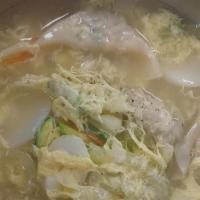 Dumpling Soup · Sliced rice cake soup with dumplings.