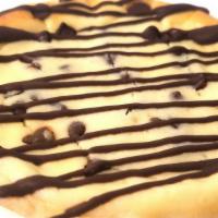 Chocolate Chip Cheesecake Cookie · Pastry Cookie filled with vanilla chocolate chip cheesecake and topped with a chocolate driz...