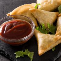 Vegetarian Samosas · Four pieces of filo dough filled with carrot, green onions, corn and potatoes.