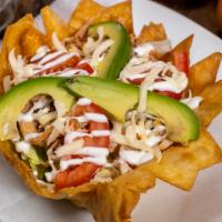 Taco Salad · Served with meat of choice, beans, rice, sour cream, lettuce, tomato, avocado and cheese.