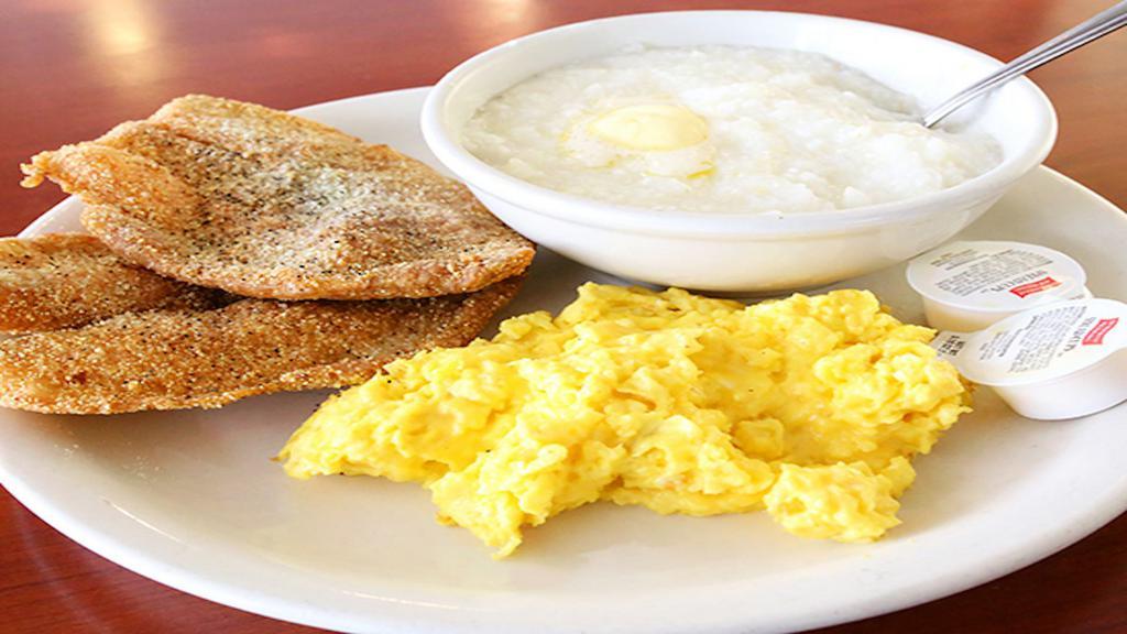 Fish And Grits · Two piece fish, 2 eggs and home-style grits.