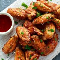Hot Chicken Wings · Oven-baked chicken wings crispy to perfection topped with hot sauce. Served with Ranch.