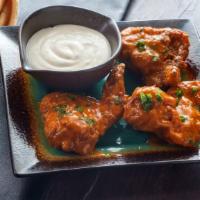 Bleu Cheese Chicken Wings · Oven-baked chicken wings crispy to perfection topped with rich bleu cheese dressing. Served ...