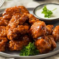 Boneless Hot Wings · Boneless! Oven-baked chicken wings crispy to perfection topped with hot sauce. Served with R...