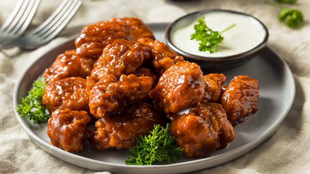 Boneless Hot Wings · Boneless! Oven-baked chicken wings crispy to perfection topped with hot sauce. Served with Ranch.