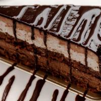 Chocolate Temptation · Chocolate cake filled with chocolate & hazelnut creams, hazelnut crunch and chocolate glaze.