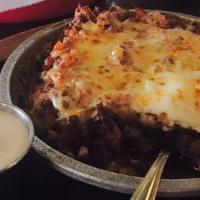 Queso Fundido · Melted Chihuahua cheese with choice of chorizo, chicken, steak or shrimp. Served with corn, ...