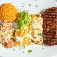 Carne Asada Tampiquena · Marinated grilled skirt steak paired with a cheese stuffed enchilada covered with mole sauce.