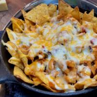 Chicken Nachos · Classic chicken nachos with melted cheese, pico de gallo, beans, and your choice of toppings.