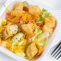 House Salad · Lettuce, tomatoes, shredded cheese, & croutons. Served with dressing.