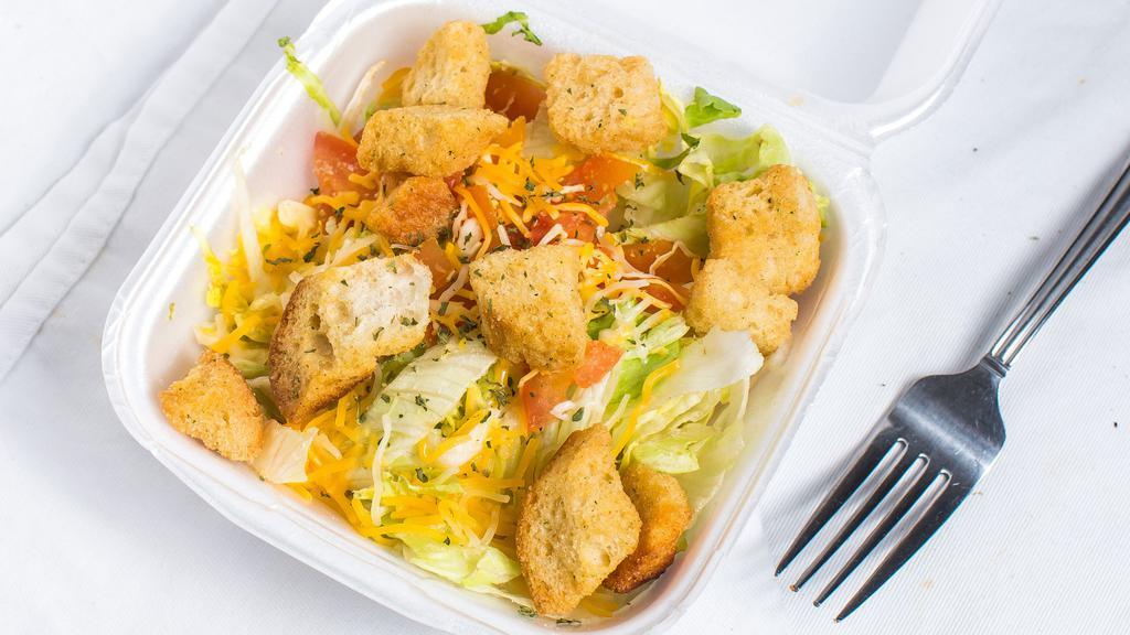 House Salad · Lettuce, tomatoes, shredded cheese, & croutons. Served with dressing.