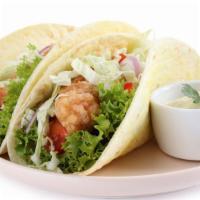 Fish Taco Trio · Flaky, battered and fried fish fillets, served with chopped onions and cilantro on fresh cor...