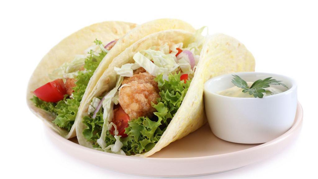 Fish Taco Trio · Flaky, battered and fried fish fillets, served with chopped onions and cilantro on fresh corn tortillas. Comes with a side of rice and beans.