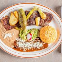 Carne A La Tampiquena · Grilled steak one cheese enchilada topped with mole sauce and a side of guacamole.