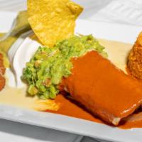 Burrito Mexico · Filled with carne azada and grilled onions, covered in three different sauces, guacamole and...