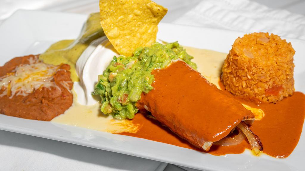 Burrito Mexico · Filled with carne azada and grilled onions, covered in three different sauces, guacamole and sour cream, served with rice and beans.