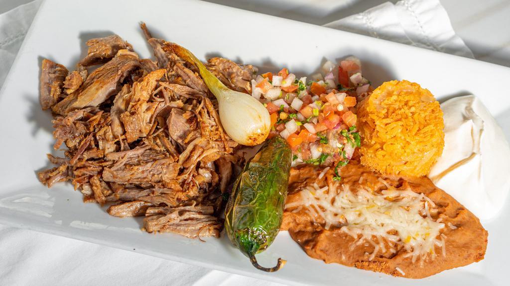 Carnitas · Gluten-free. Pork delicately seasoned with spices and herbs, cooked golden brown, served with rice, beans, pico de gallo, sour cream and tortillas.
