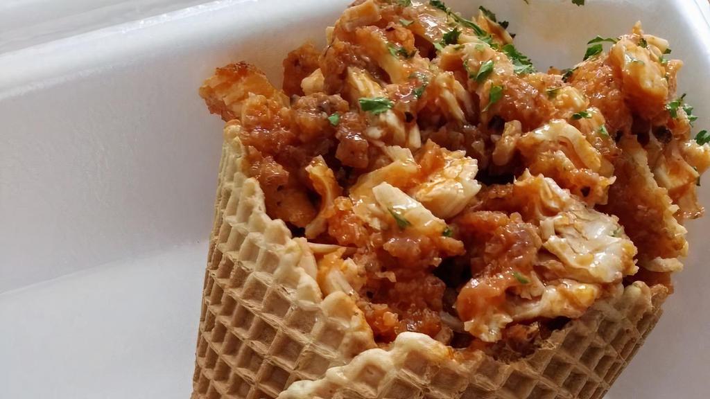 Chicken In A Cone · Waffle cone stuffed with chicken and drizzled with your choice of sauce.
