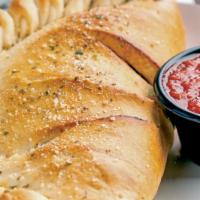 Calzone · Mozzarella cheese wrapped with butter-brushed dough, sprinkled with Parmesan, and oregano, t...