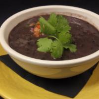 Black Bean Soup · Black bean soup garnished with pico de gallo.
