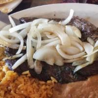 Steak Zamora · skirt steak seasoned with our own chimichurri sauce, topped with fried onion and black beans...