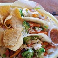 Taco Dinner · Served with three tacos, your choice of meat, Mexican rice, and refried beans.