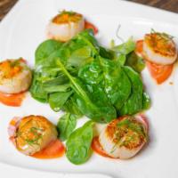 Golden Scallops · Jumbo scallops, seared golden brown over fresh sliced tomatoes and our special sauce.