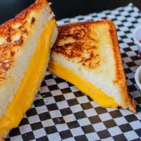 Grilled Cheese · Two slices of thick texas toast with a combination of cheddar and american cheese grilled to...