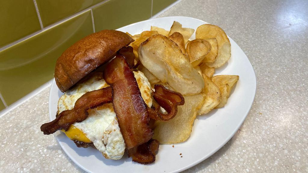 Rhody'S Breakfast Burger · Perhaps one of the best burgers of all time!  1/3 lb all beef patty topped with cheddar cheese, crisp bacon and a fried egg sandwiched between a perfectly toasted Brioche bun.