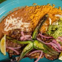 Carne Asada · Thinly sliced grill steak served with beans and guacamole salad.