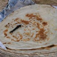 Roti · Whole wheat flatbread baked in a tandoor clay oven.