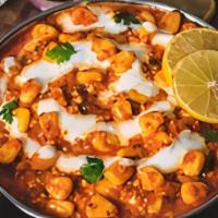 Chana Masala · Chickpeas slowly cooked with onion, tomatoes, bell peppers, and spices.