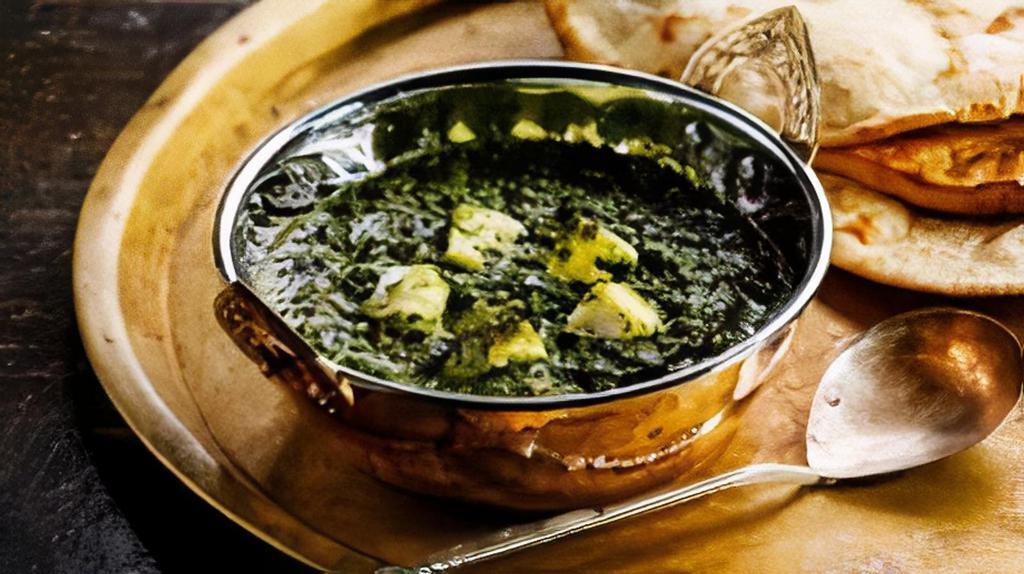 Saag Paneer · Classic spinach curry dish with cubes of homemade cheese.