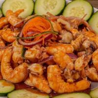 Botana De Camarón Y Pulpo / Octopus And Shrimp Snack Platter · Camarón cocido, pulpo, pepino, cebolla, aguacate y salsa negra. / Cooked shrimp, octopus, cu...