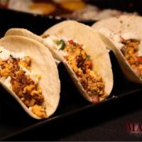 Breakfast Tacos · Chorizo, egg and cheese served on flour or corn tortilla with beans and breakfast potatoes.