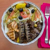 River Grill Combo Plate · Chicken shish kabob, lamb shish kabob and kufta shish kabob on a bed of rice with grilled on...