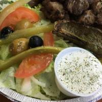 Lamb Shish Kabob Plate · Grilled marinated lamb served on a bed of rice, topped with grilled onions, grilled green pe...