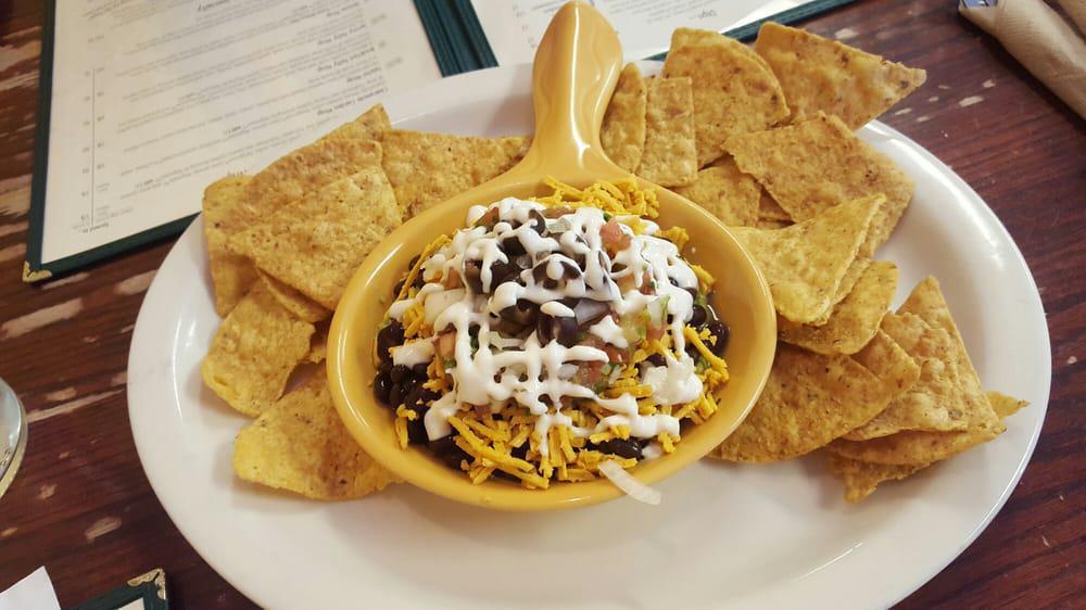 7 Layer Sombrero Dip · Guacamole, salsa, daiya cheeze, black beans, house-made vegan sour cream, black olives, and onion. Served with organic chips (enough for two). CONTAINS soy