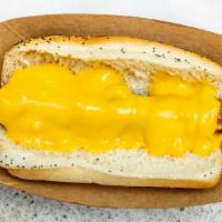 Francheezy Dog · Hot dog wrapped in bacon and topped with cheese sauce.