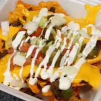Philly Cheesesteak Nachos  · Green peppers and onions 
Nacho cheese , sour cream , lettuce,tomato,onions,jalapeños & side...
