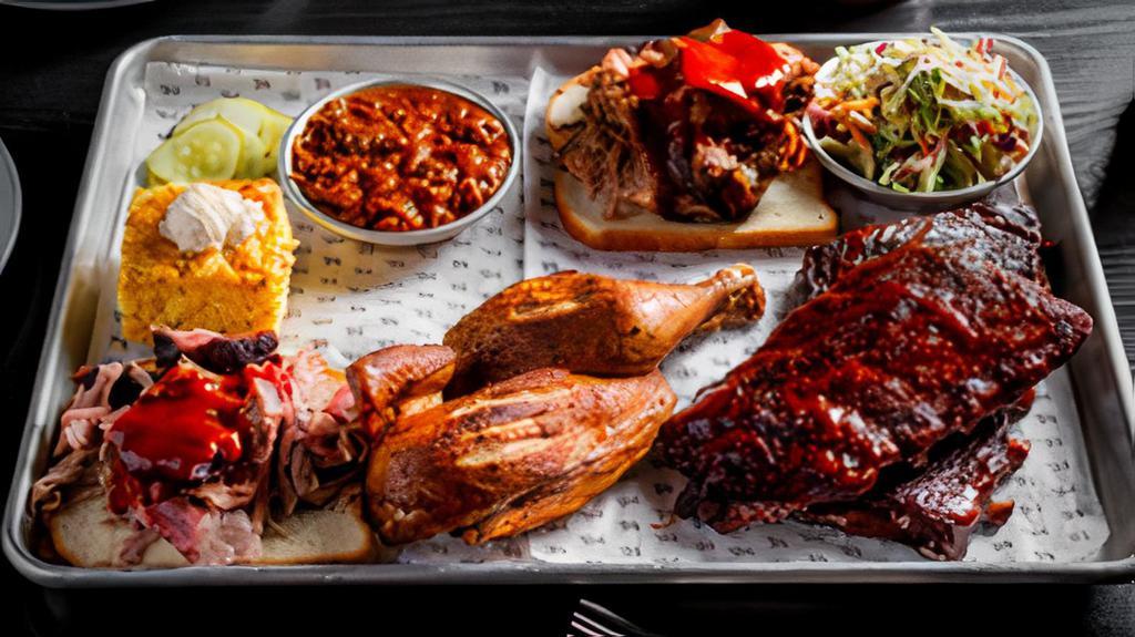 Big City Eats · Our biggest platter, designed for 3-4 people to share. Includes your choice of two half orders of ribs, half of a rotisserie chicken, your choice of two smoked meats and three of your favorite sides. Served with a side of pickles and white bread.