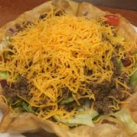 Taco Salad · Your choice of chicken or beef, atop a bed of fresh greens with chopped onions, green pepper...