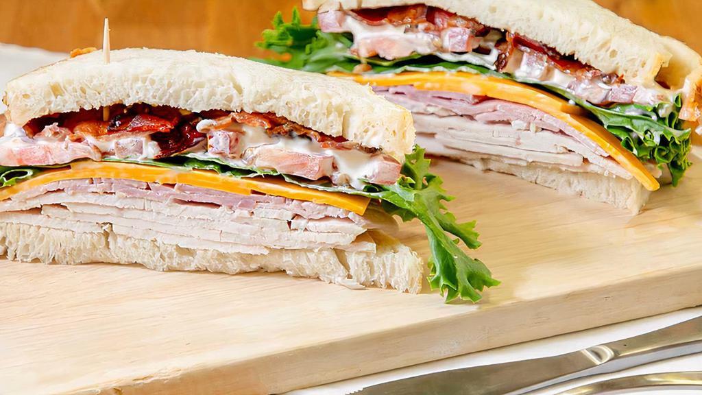 Maple Grove Club · Sliced smoke turkey, ham, bacon, provolone cheese, mayo, onion, spinach and tomato on bread. 630-690 calories.