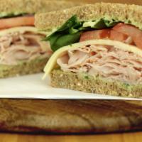 Turkey Goddess · Our house-made green goddess dressing drizzled over slices of turkey breast and creamy Swiss...
