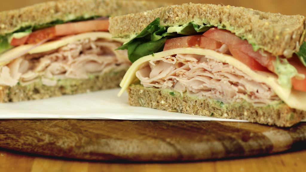 Turkey Goddess · Our house-made green goddess dressing drizzled over slices of turkey breast and creamy Swiss cheese. Includes spinach, tomato, onion, cucumber, sweet pepper on Dakota bread. 630-690 calories.