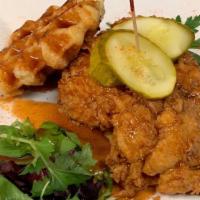 Chicken And Waffle · Our crispy chicken tenderloins, scrambled eggs, & cheddar cheese, nestled between two Belgia...